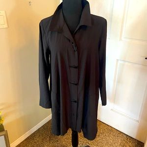 Mid length black silky blouse with triangle shaped buttons